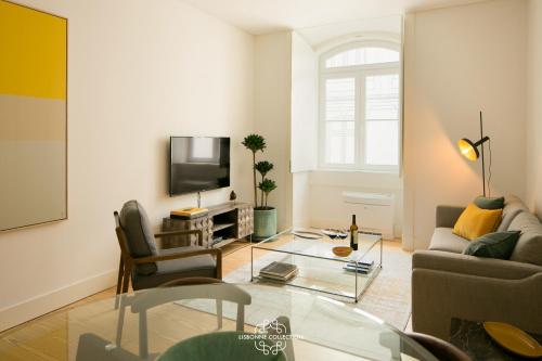 a living room with a couch and a tv at Downtown Sleek Apartment 65 by Lisbonne Collection in Lisbon