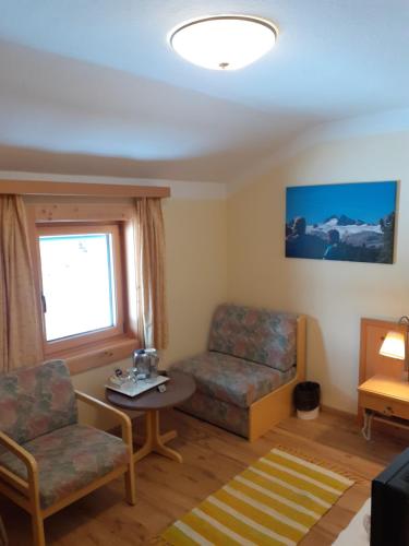 a living room with a couch and a table at Pension Hirlatz in Hallstatt