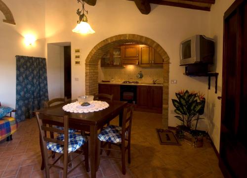 a kitchen and dining room with a table and chairs at Casa il Ponte in Chianni