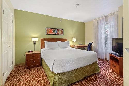 a bedroom with a bed and a flat screen tv at Extended Stay America Suites - Newport News - Yorktown in Newport News