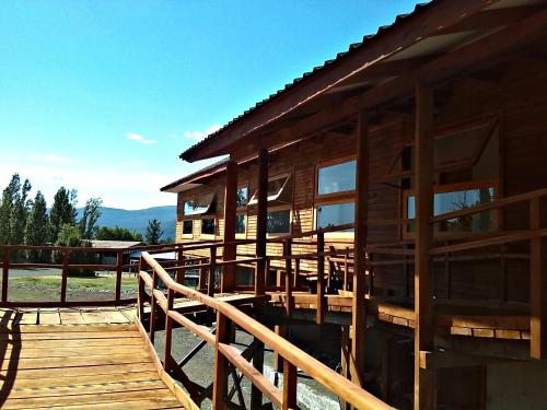 a large wooden house with a wooden deck at Eco Hotel Antuco in Antuco