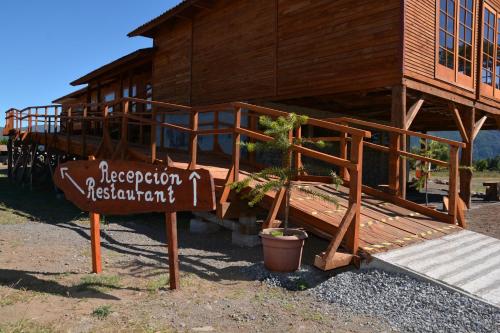 a sign in front of a building with a house at Eco Hotel Antuco in Antuco
