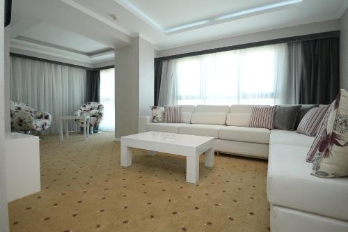 a living room with a white couch and a table at NK Hotel in Izmir