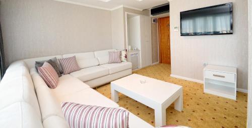 a living room with a white couch and a table at NK Hotel in Izmir