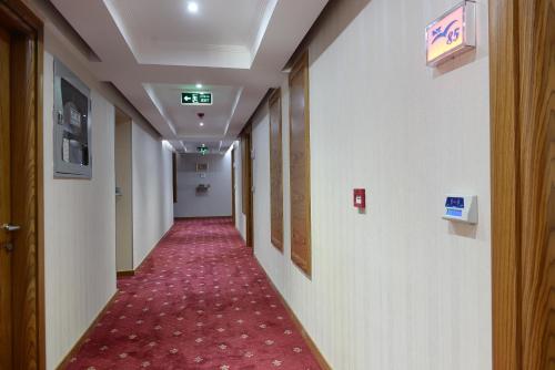 a corridor of a hospital hallway with a red carpet at NK Hotel in Izmir