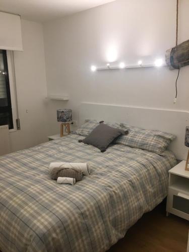 a large bed with two pillows on top of it at Apartamento Pamplona Comfort in Pamplona