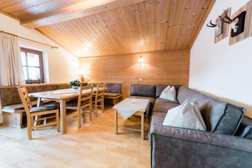 a living room with a couch and a table at Der Erlenhof in Grossarl