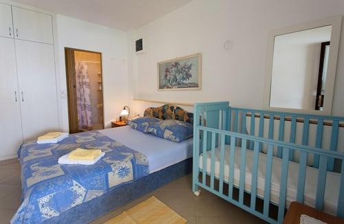 sypialnia z niebieskim łóżeczkiem dziecięcym w pokoju w obiekcie Large Terrace Apartment in Omisalj 3623-3 w mieście Omišalj