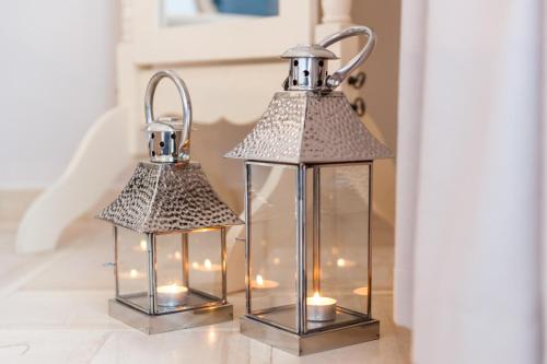 two lanterns sitting on a table with lights at Anna Platanou Hotel in Parikia