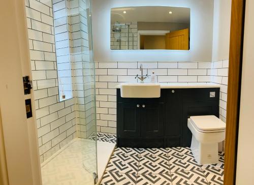 a bathroom with a sink and a toilet at The Mews Cottage, with parking, Yarm in Yarm