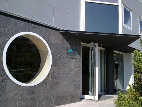a building with a circular window on the side of it at Hotel Montmeló in Montmeló