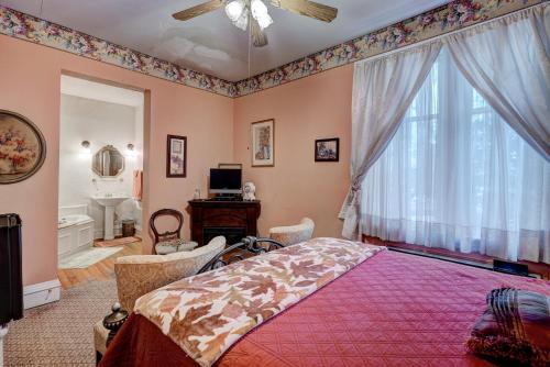 a bedroom with a bed and a large window at Grandison Inn in Oklahoma City