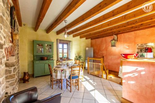 a kitchen and dining room with a table and chairs at Gîte de Franc Saône et Loire référencé 1961 Les Perrières entre Autun et Le Creusot chez Maymard Yannick in Antully