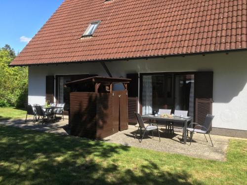 a house with a table and chairs in front of it at Ferienwohnungen Wagner am Brombachsee in Pleinfeld