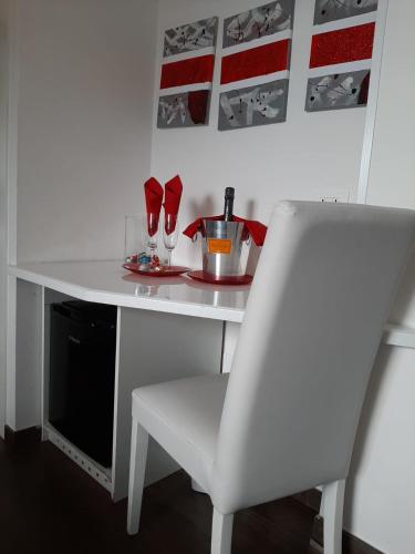 a white desk with a white chair and a table and a chair at Caos Calmo in Rome