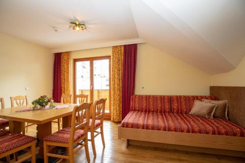 a living room with a couch and a table at Alpenresidenz Trisanna in Ischgl