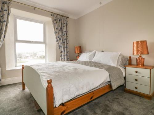 a bedroom with a large bed and a window at East Hill Farm in Truro