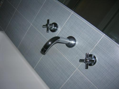 a shower with two faucets on a tile wall at Casa Vacanze Trapani Via Mercè in Trapani