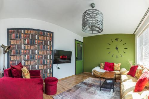 a living room with a large clock on the wall at Urban style in the Centre in Varna City