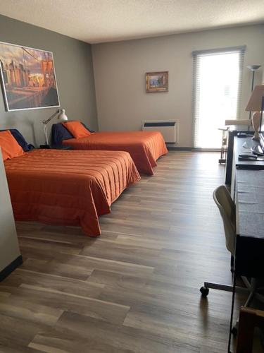 um quarto de hotel com duas camas e uma janela em Motel Populaire em Trois-Rivières