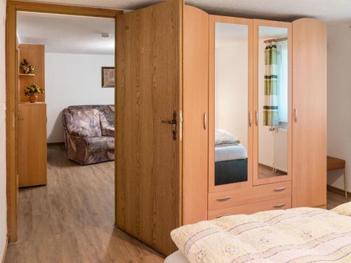 a bedroom with a wooden closet and a bed at Scintillating Apartment in Wienrode near City Centre in Wienrode