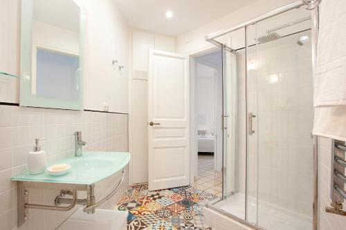 a bathroom with a sink and a glass shower at Casa Muntaner in Barcelona