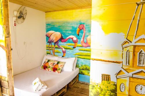 a room with a bed with a painting on the wall at Nuestros Tres Tesoros II in Playa Blanca
