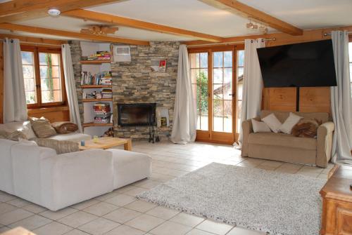 a living room with two couches and a fireplace at Chalet Edelweiss - Verbier, Mountain Views, Jacuzzi! in Vollèges