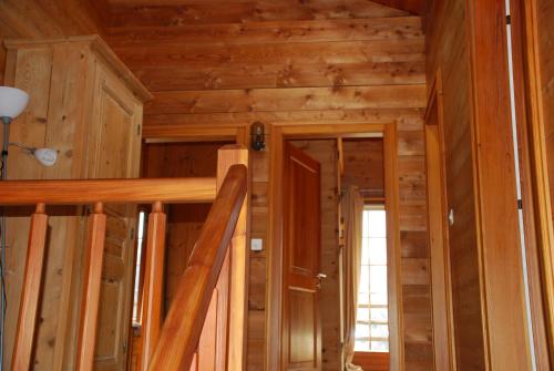 a room with wooden walls and stairs in a cabin at Chalet Edelweiss - Verbier, Mountain Views, Jacuzzi! in Vollèges