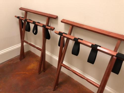 a wooden rack with bow ties hanging on a wall at Suites at 249 in Culpeper