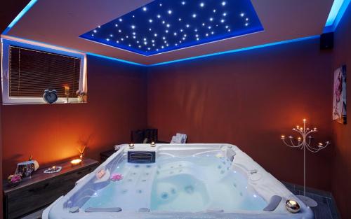 a bathroom with a tub with a star ceiling at Hotel Stella Maris - Style & Comfort in Vodice