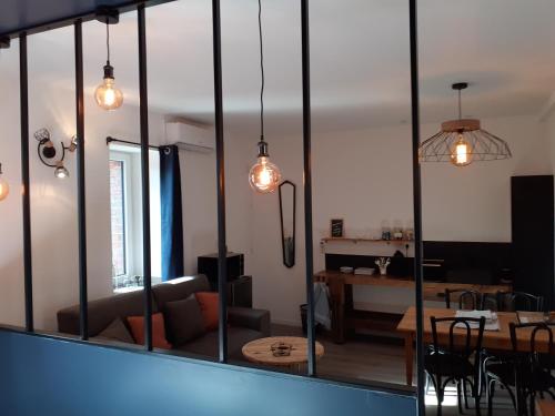 a living room with a large glass wall at CHARMES EN VILLE Le Charme Poétique in Montluçon