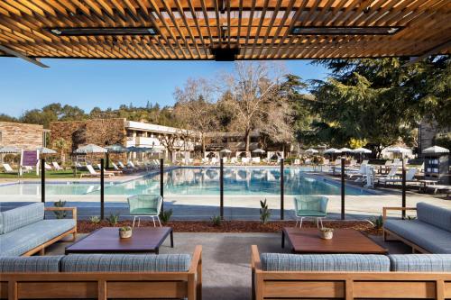 a pool at a resort with tables and chairs at Flamingo Resort in Santa Rosa