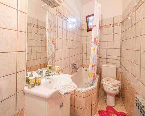 a bathroom with a sink and a toilet and a tub at Apartment in Vrbnik/Insel Krk 14527 in Vrbnik