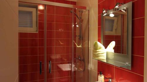 a bathroom with a shower and a sink and a mirror at Malinska Apartment 2 in Sveti Anton