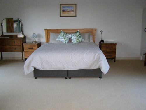 a bedroom with a bed with two dressers and a bed sidx sidx at 2 Views at Tasman in Tasman
