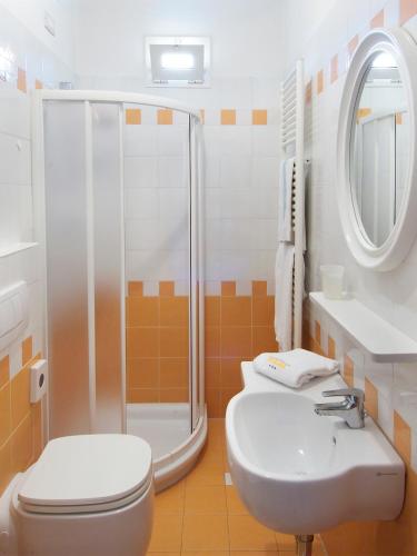 a bathroom with a shower and a toilet and a sink at Sweet Home Appartamenti in Bellaria-Igea Marina
