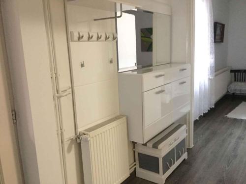 a kitchen with a white refrigerator and a mirror at Holiday Home Balatonbereny 2 in Balatonberény