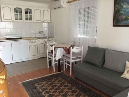 a living room with a couch and a table and a kitchen at Holiday Home Balatonbereny 16 in Balatonberény