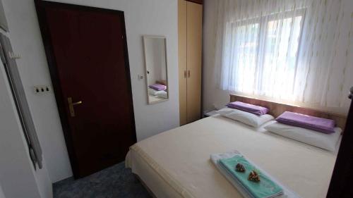 a bedroom with a bed with a tray on it at Studio in Vantacici/Insel Krk 14419 in Vantačići