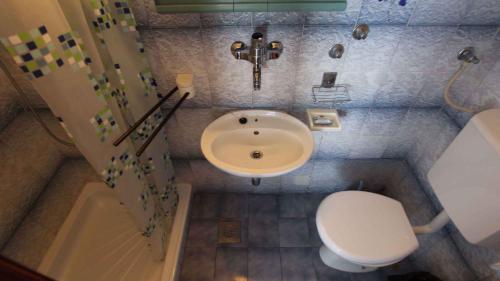 a small bathroom with a sink and a toilet at Apartment Malinska,Krk, Primorje-Gorski Kotar 10 in Vantačići