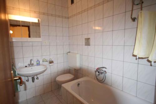 a bathroom with a sink and a toilet and a tub at One-Bedroom Apartment Silo near Sea 1 in Šilo