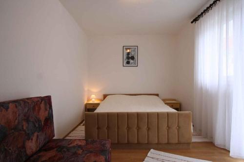a bedroom with a bed and a couch in it at Apartment in Silo/Insel Krk 14597 in Šilo