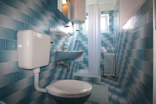 a blue tiled bathroom with a toilet and a sink at Apartment in Silo/Insel Krk 14597 in Šilo