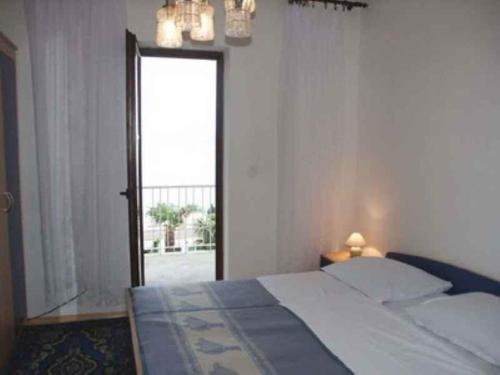 a bedroom with a bed and a large window at Studio Crikvenica 8 in Dramalj