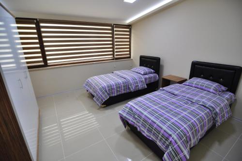 Ένα ή περισσότερα κρεβάτια σε δωμάτιο στο Dekar Apartments