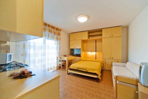 a kitchen and living room with a bed and a couch at Studio in Bibione 24407 in Bibione