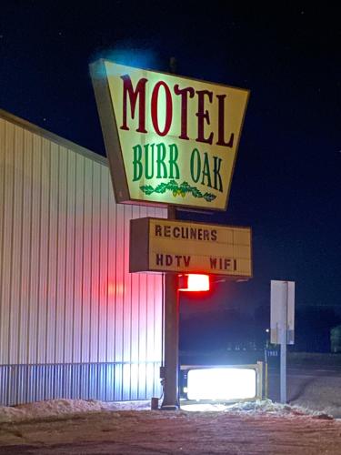 a motel burn oak sign in front of a building at Burr Oak Motel in Algona