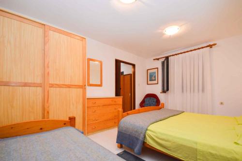 a bedroom with two beds and a dresser at Apartment Pjescana Uvala/Istrien 11126 in Vintijan