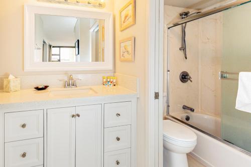 a bathroom with a sink and a toilet and a mirror at Diamond Head & Ocean View Gem Near Waikiki Beach, Parking's On Us in Honolulu